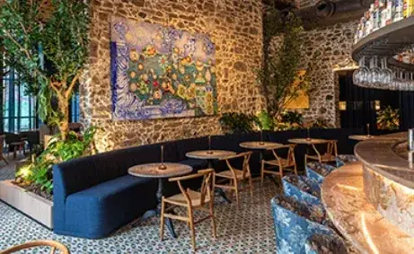Bar com paredes de pedra aparente e painel de azulejos